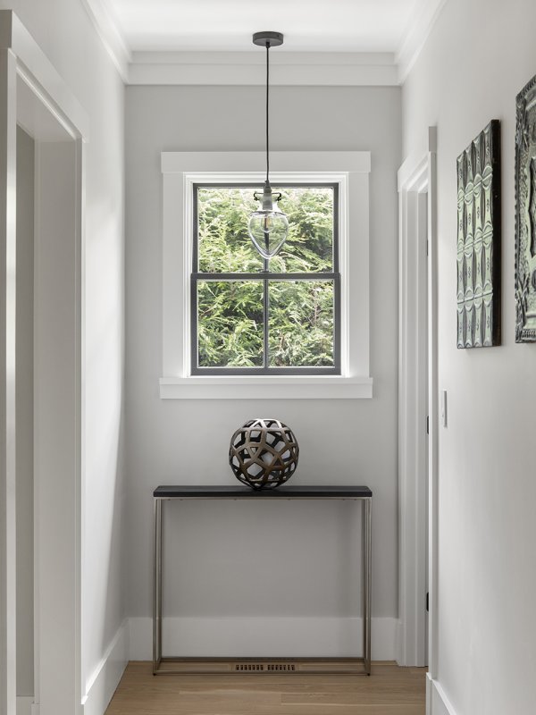hallway with accent furniture and pendant © Jacob Lilley Architects Needham, MA