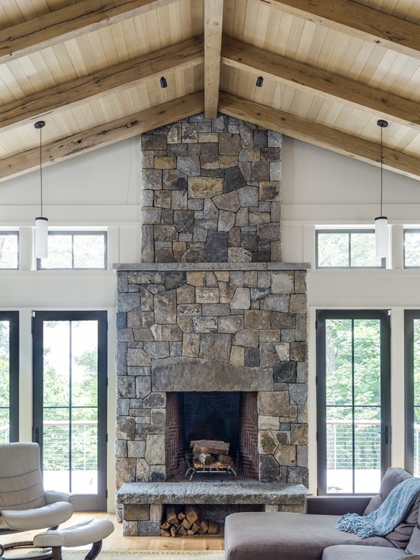 granite wood burning fireplace with granite bench© Jacob Lilley Architects Lexington, MA