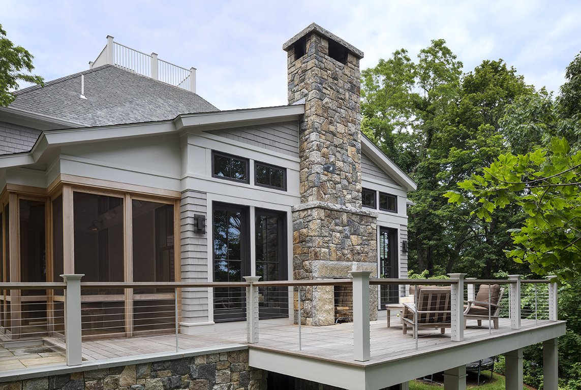 exterior addition with oublesied granite fireplace© Jacob Lilley Architects Lexington, MA
